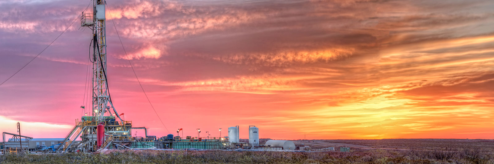 Sun setting over a rugged landscape with power lines. Sun setting over a rugged landscape with power lines.