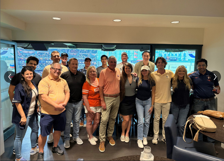 A group of people smiling and posing together indoors.
